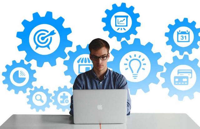 Home sentado diante dun portátil.