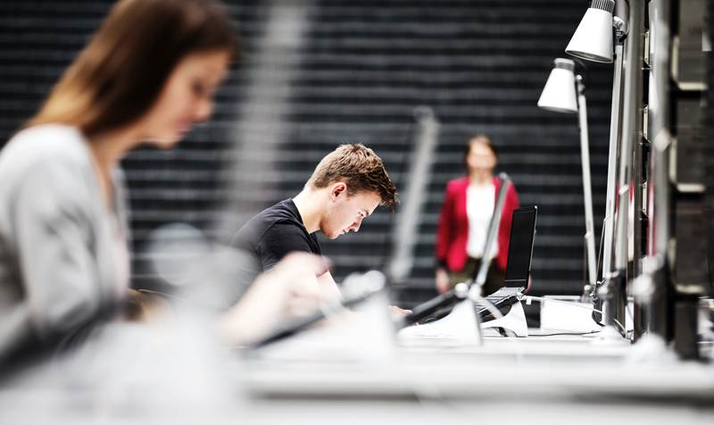Estudantes diante de portátiles.