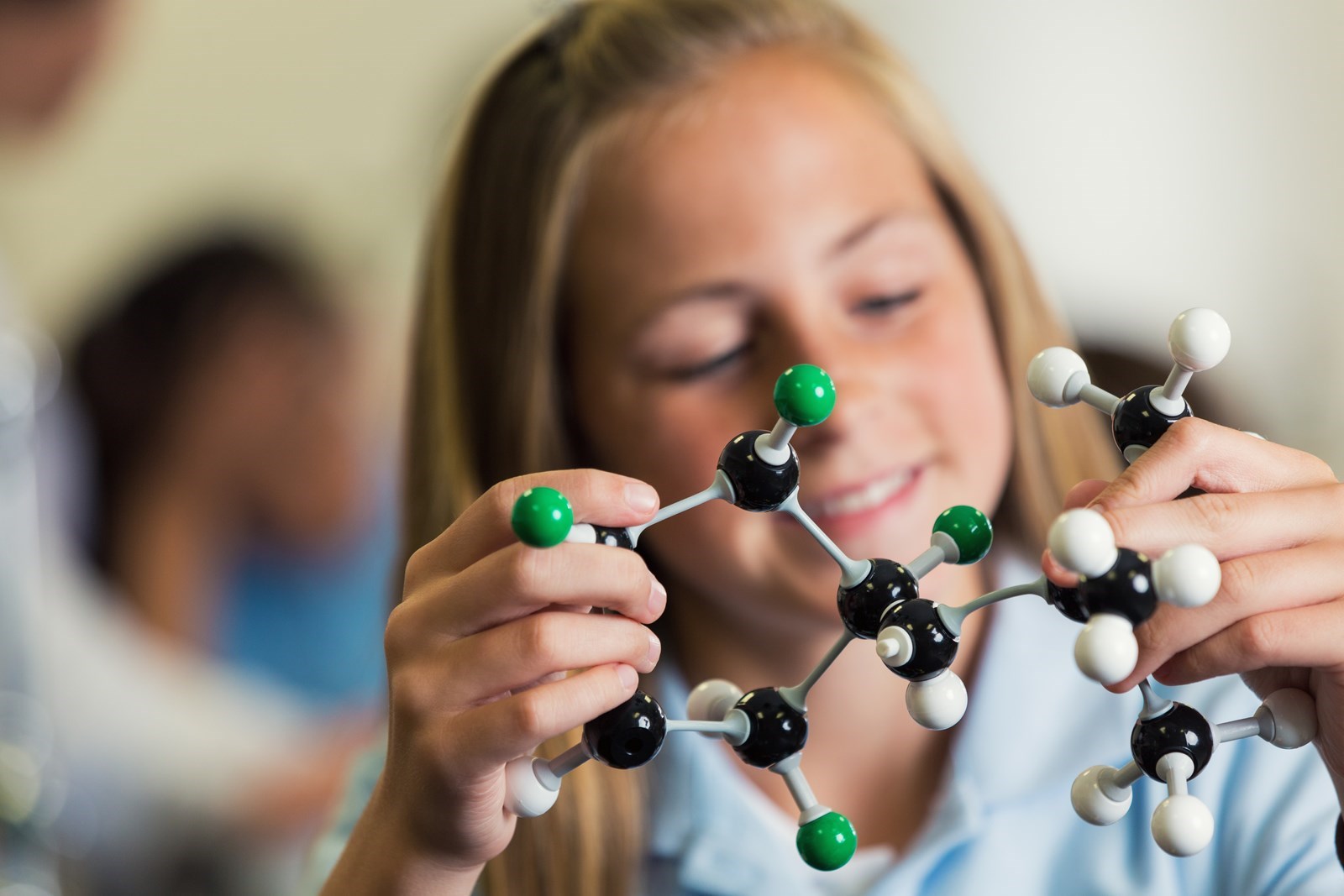 Moza sostendo un modelo de molécula.
