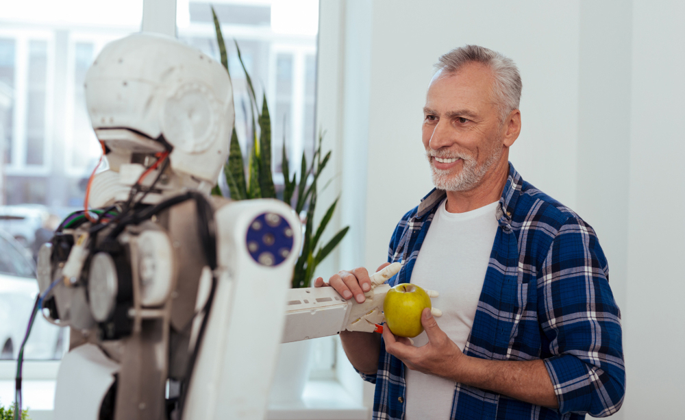 Un home interactúa cun robot.