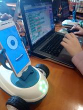 Niña programando un robot Robobo en un portátil.