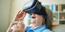 Mujer anciana usando un casco de realidad virtual.