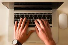 Manos sobre el teclado de un portátil.